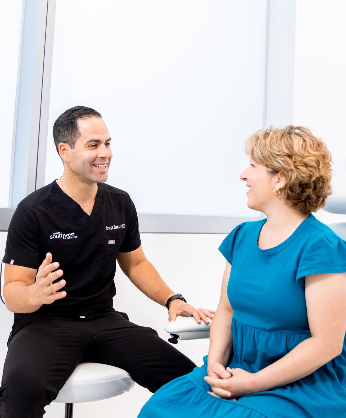 Doctor consulting with patient in medical setting.