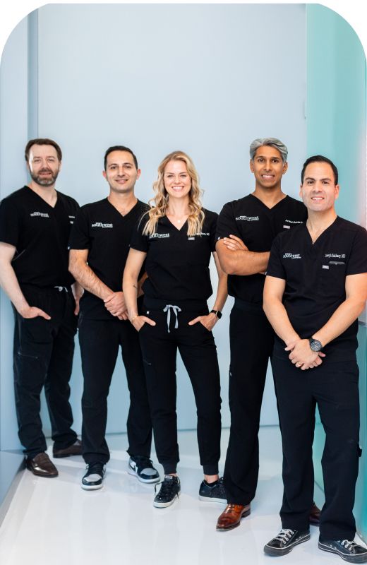 Phoenix plastic surgery medical team posing in scrub uniforms.